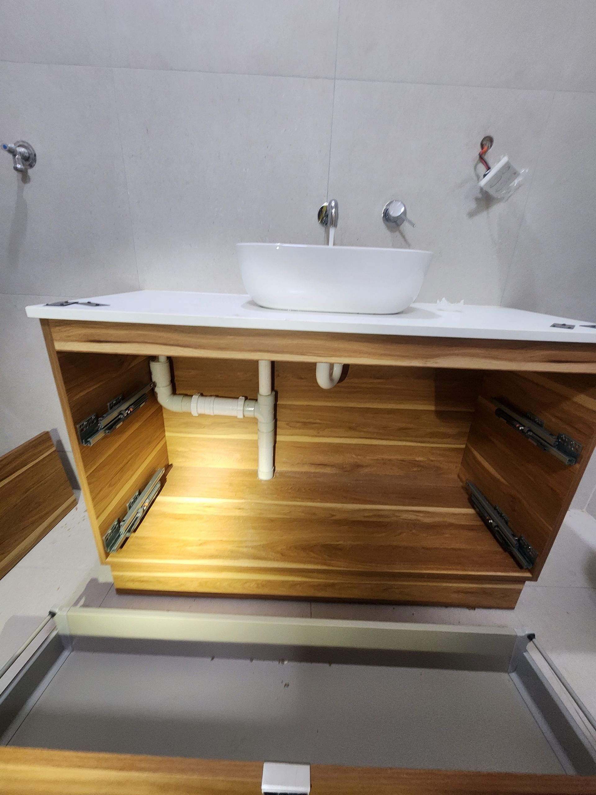 A White Toilet Sits in an Unfinished Room With Various Plumbing Tools — Kingdom Plumbing Services in Gordonvale, QLD