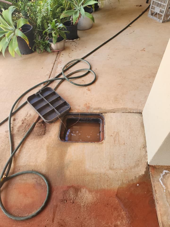 An Open Square Irrigation or Water Valve Box Filled With Water — Kingdom Plumbing Services in Gordonvale, QLD