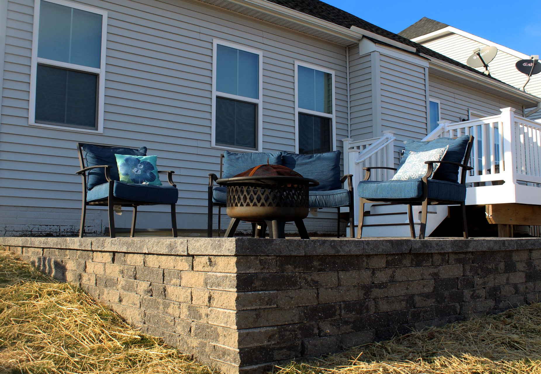 Outdoor living space beautifully decorated with furniture on a patio.