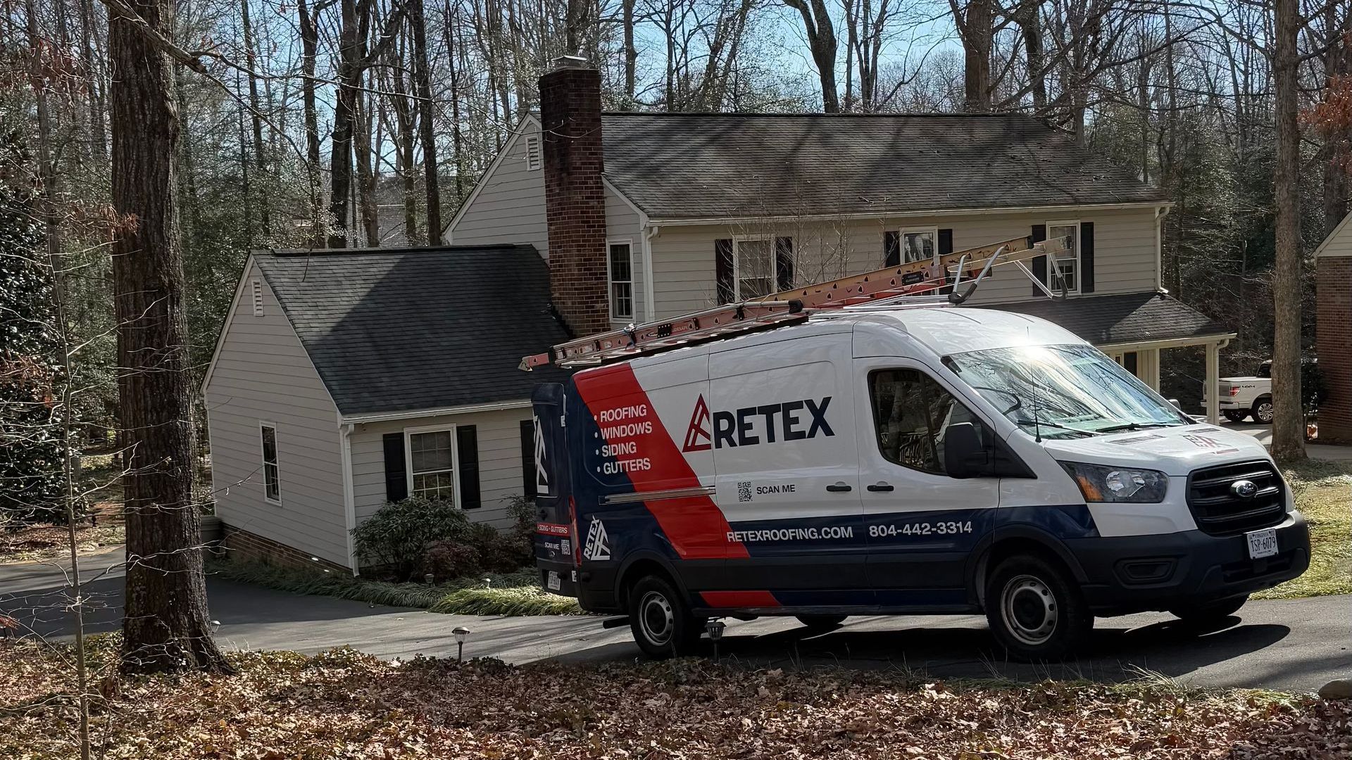 White RETEX service van parked in front of a house.