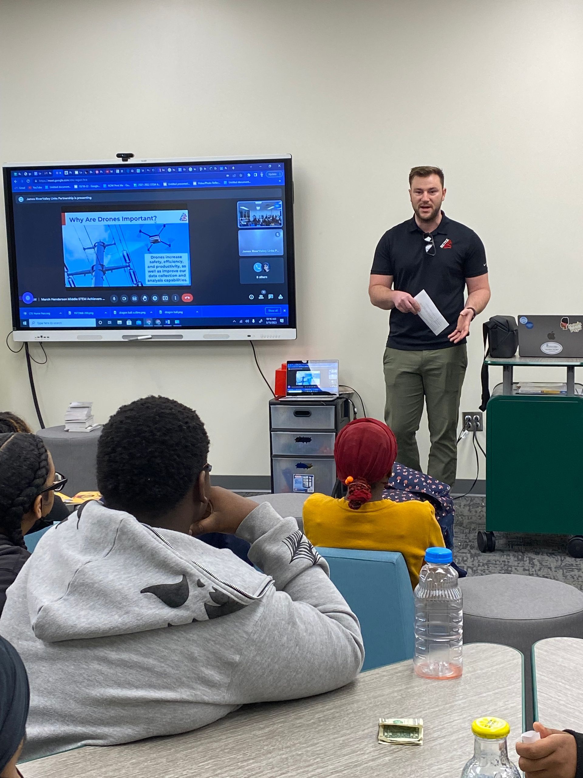 Photo of RETEX's Josh Lewis teaching STEAM students about drone use and rules of flight.