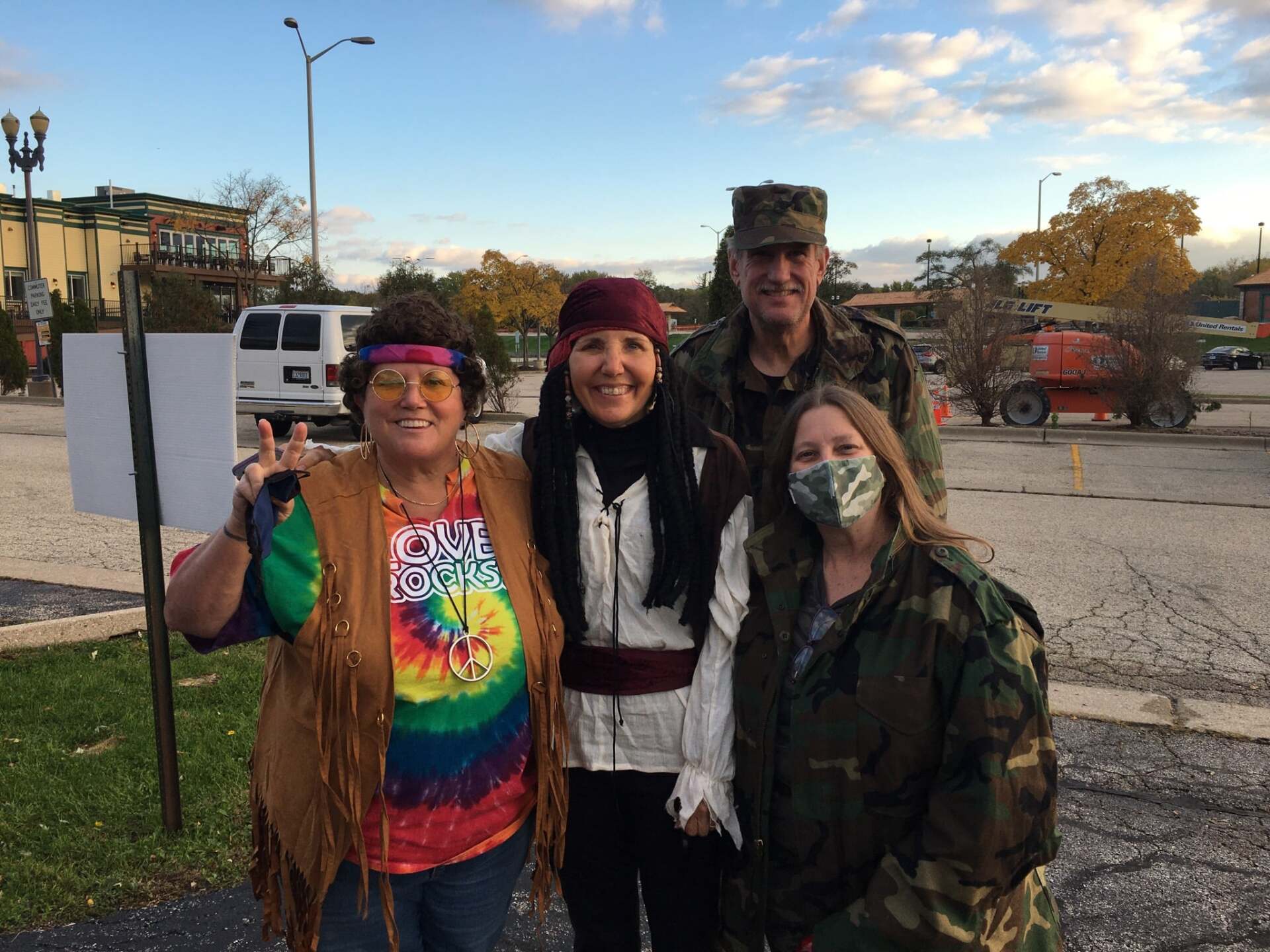 A group of people are posing for a picture in a parking lot.