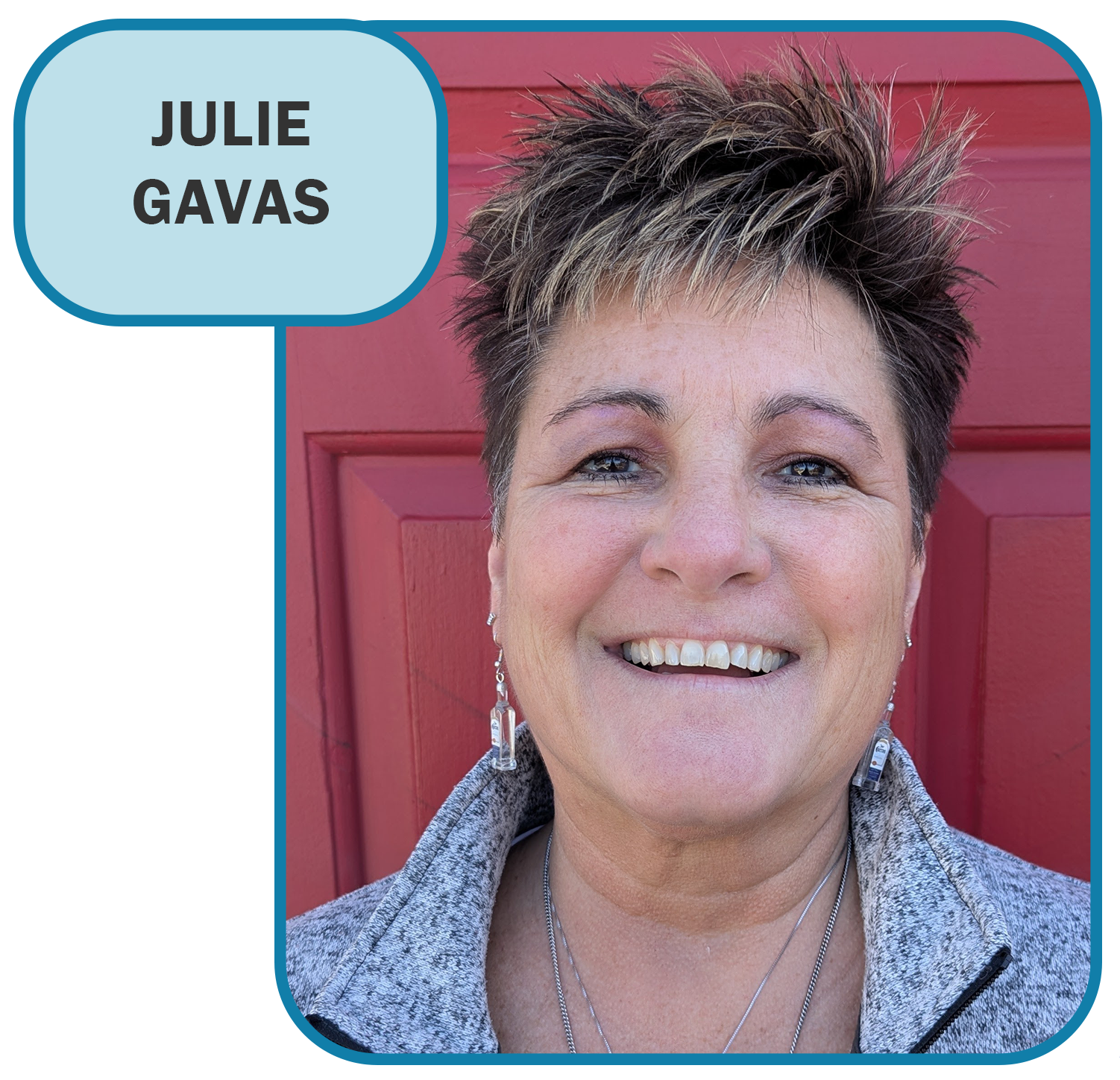 Julie gavas is smiling in front of a red door