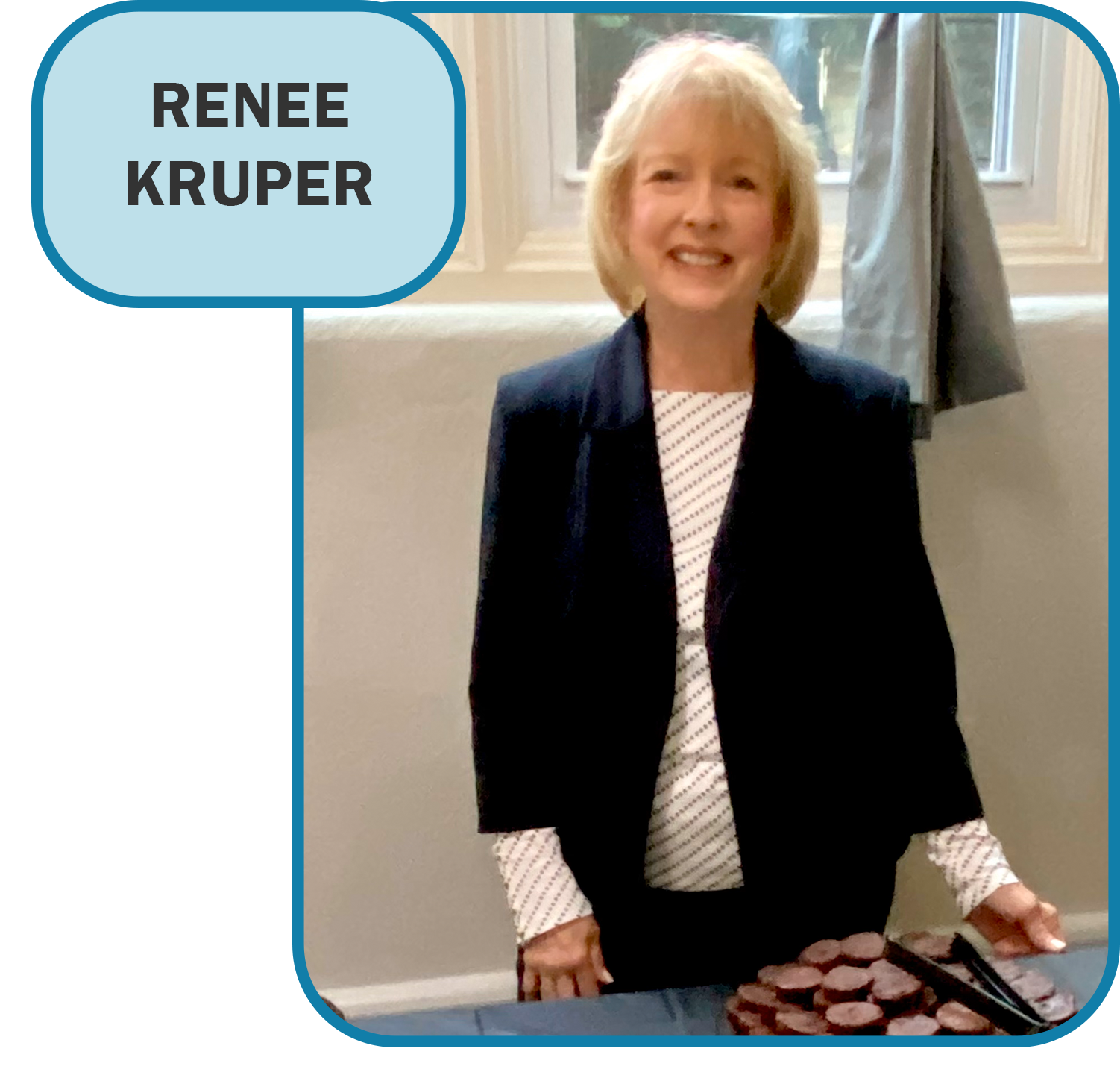 Renee kruper is standing in front of a window