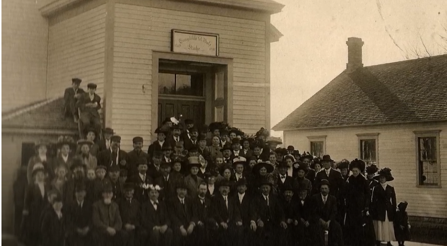 A large group of people standing in front of a building
