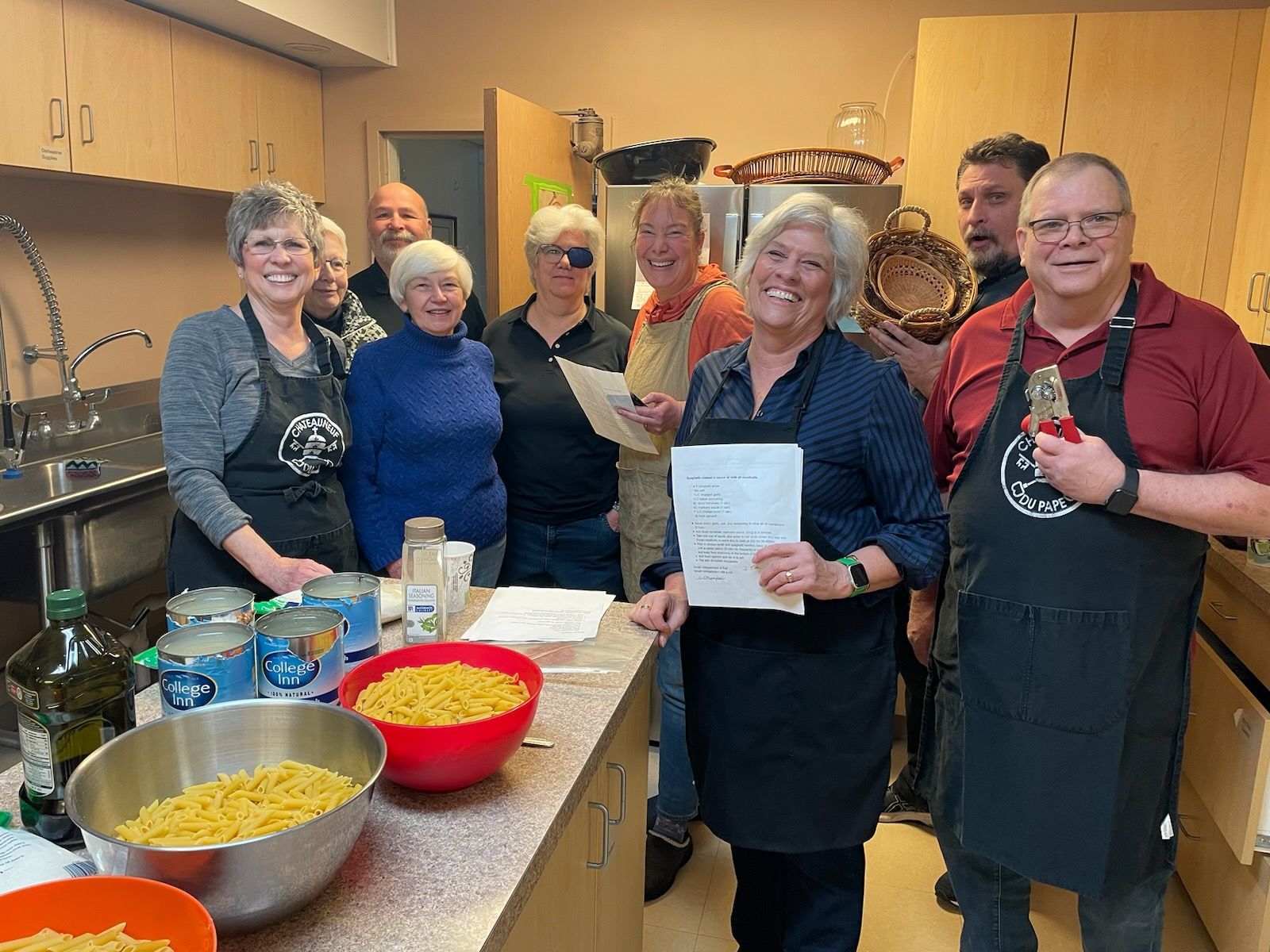 A group of people are posing for a picture in a kitchen.