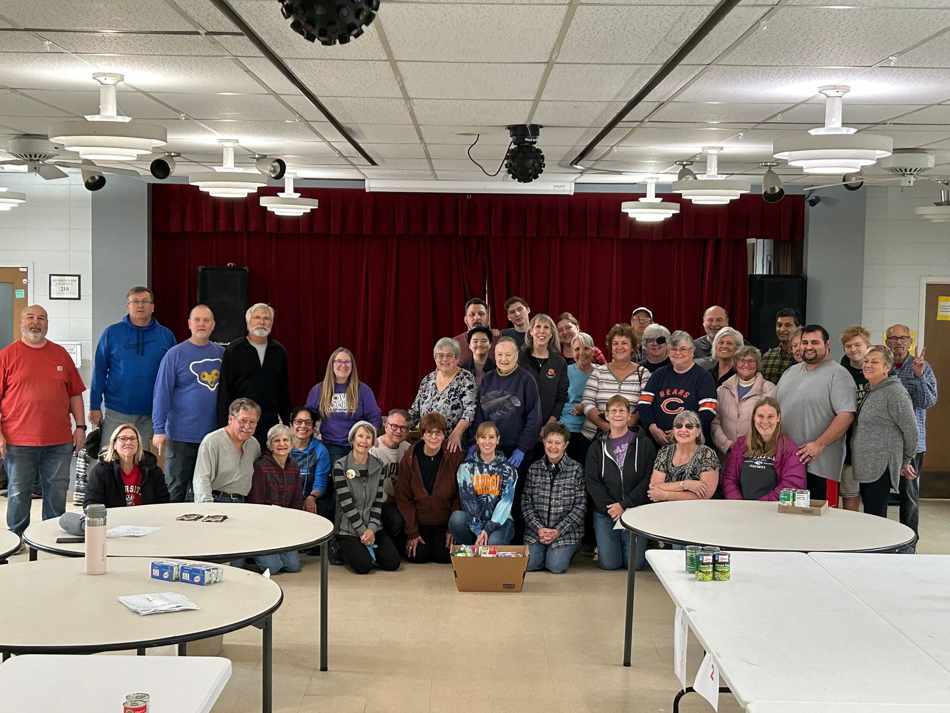 A group of people are posing for a picture in a room.