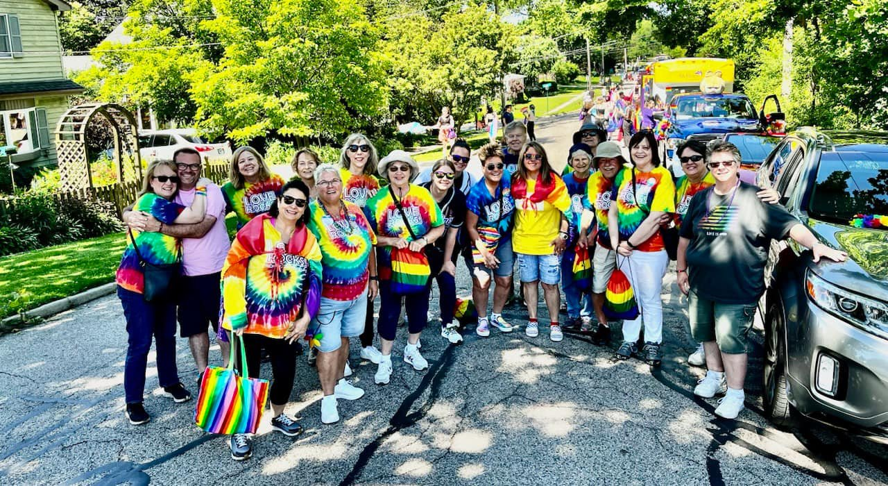 A group of people are standing on the side of a road.