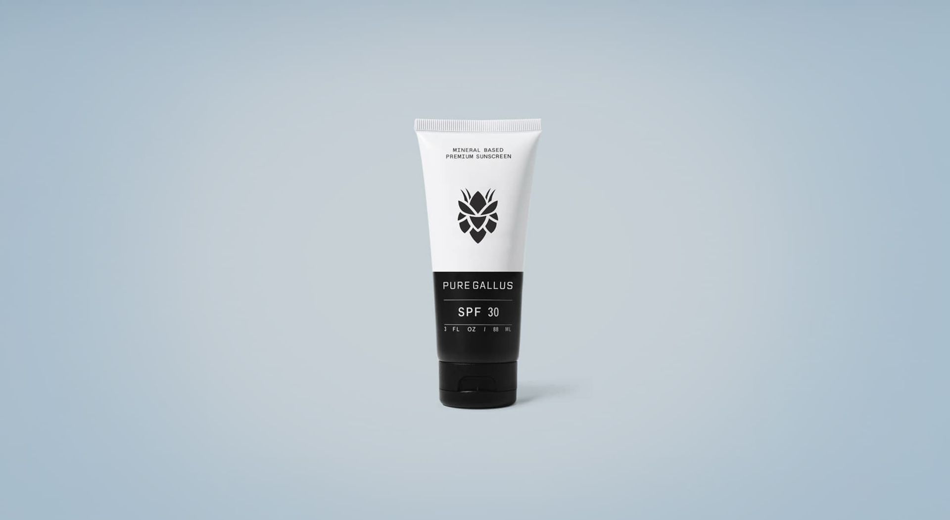 White tube of product with black text and logo against a blue background.