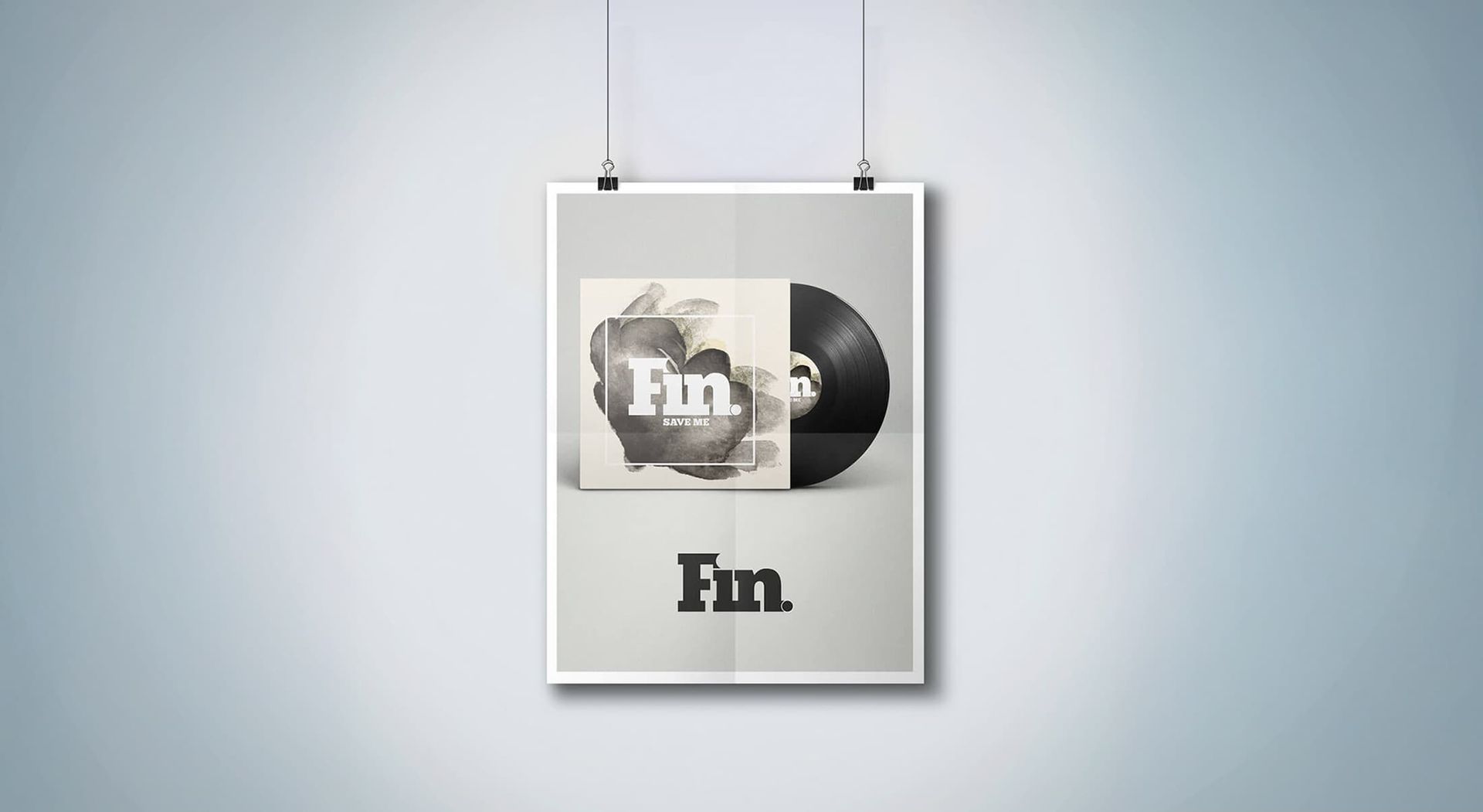 Poster with album art, a grayscale design with a vinyl record, hanging on a wall.