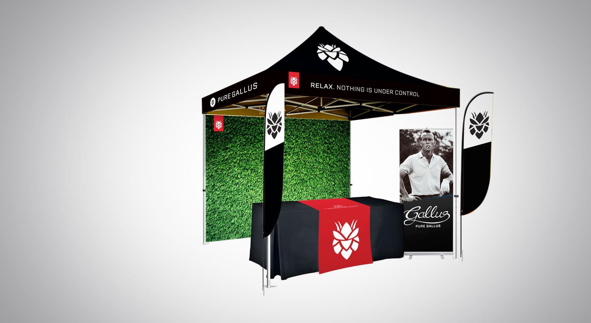 Black and red branded tent with table, display signs, and backdrop. Setting up for an event.