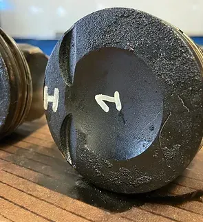 A close up of a piston with the number 12 on it