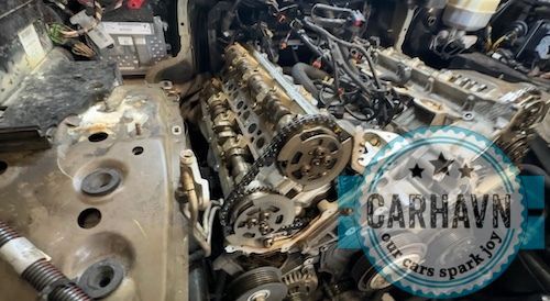 A car engine is being worked on in a garage.