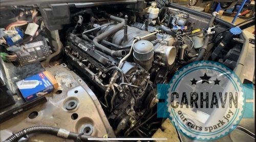 A car engine is being worked on in a garage.