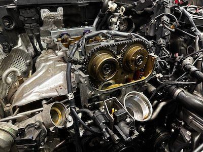 A close up of a car engine that is being worked on.