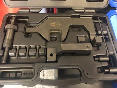 A black tool set is sitting in a case on a table.