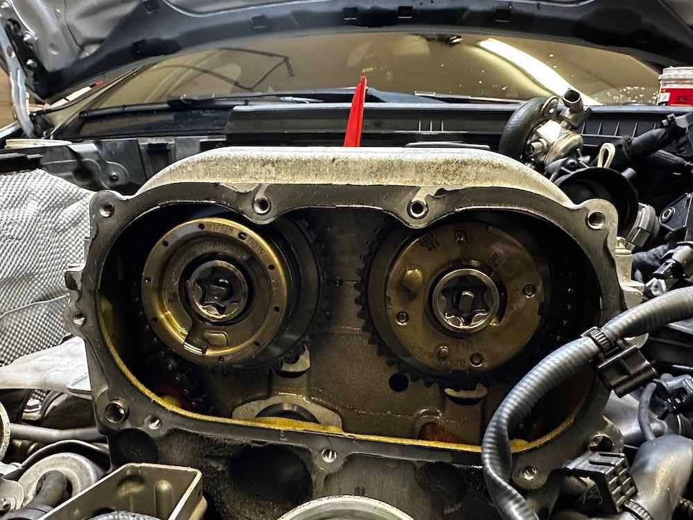 A close up of a car engine with the hood open