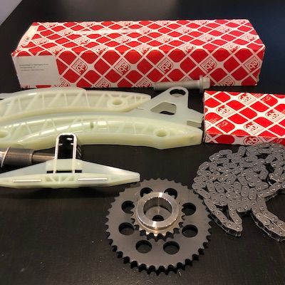 A set of timing chains and gears on a table