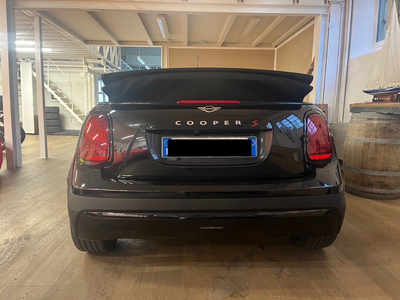 Vista posteriore di una berlina Lincoln nera parcheggiata in un garage, con targa bordata di blu.