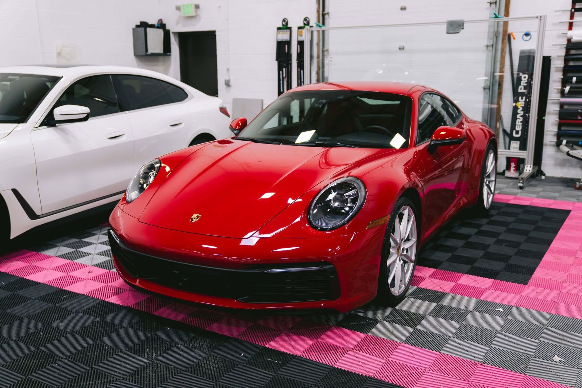 Ceramic coating on a red Porsche for paint protection and gloss.