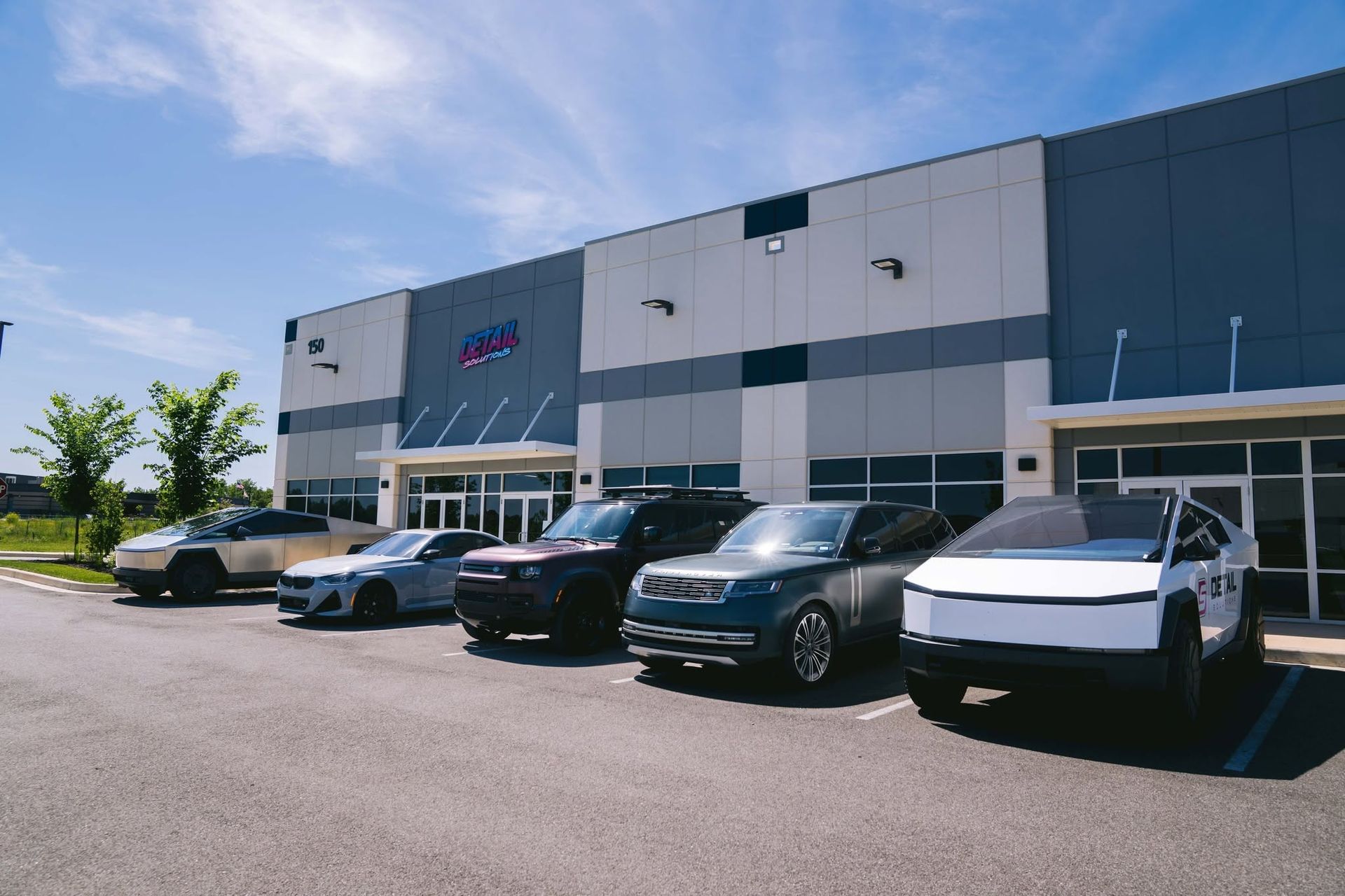 matte, gloss, and satin cars parked outside a detailing shop