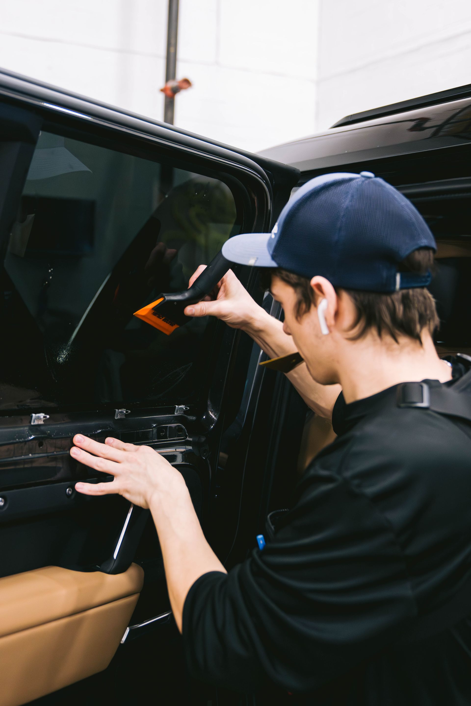 a technician applying window tint on a car
