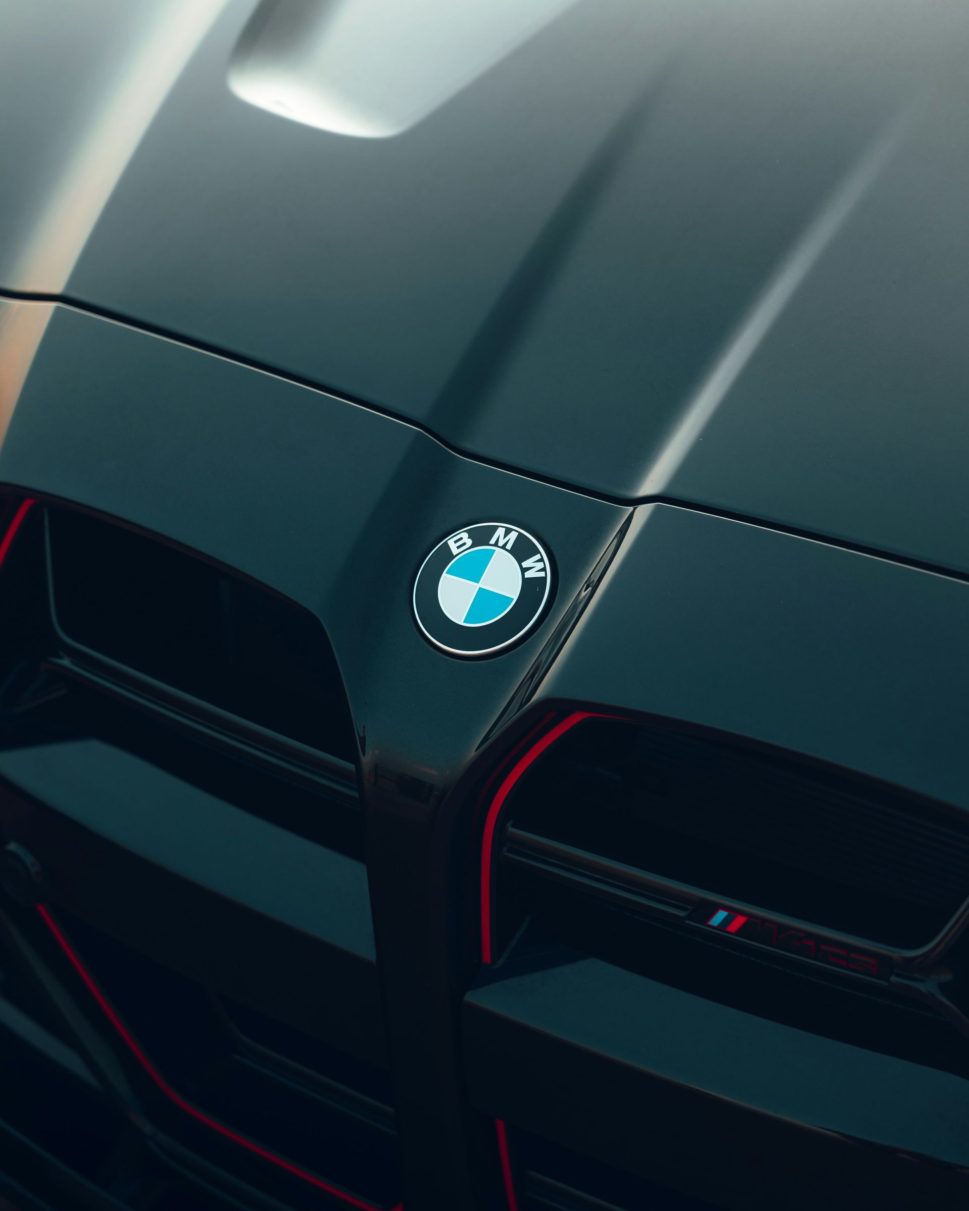 Ceramic coating finish on a black BMW hood.