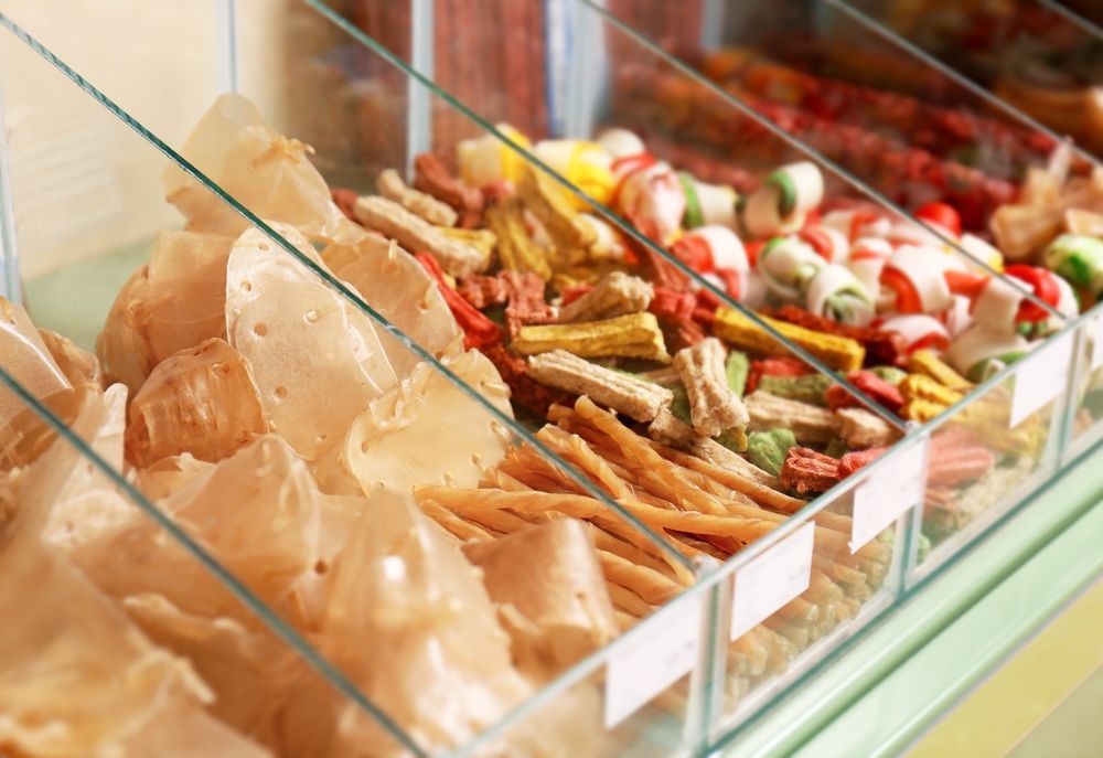 A Glass Display Case Filled With A Variety Of Snacks — Cessnock Pet & Greyhound Supplies in Newcastle, NSW