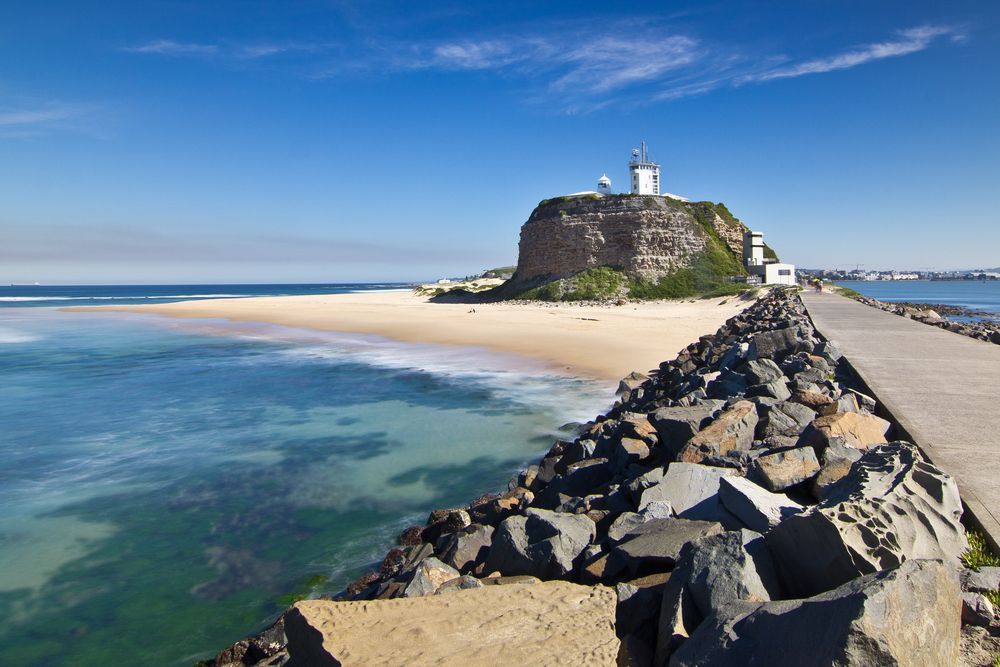 There Is A Lighthouse On Top Of A Rocky Hill Near The Ocean — Cessnock Pet & Greyhound Supplies in Newcastle, NSW
