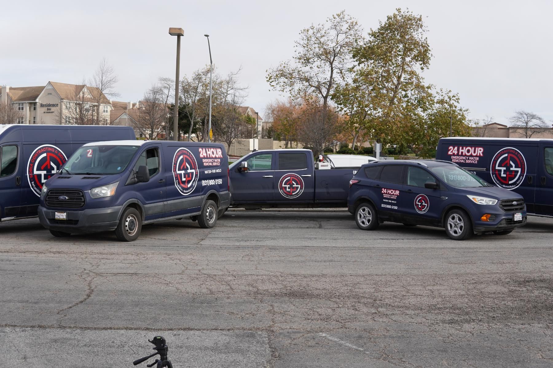 a group of people standing in front of a 24 hour van .