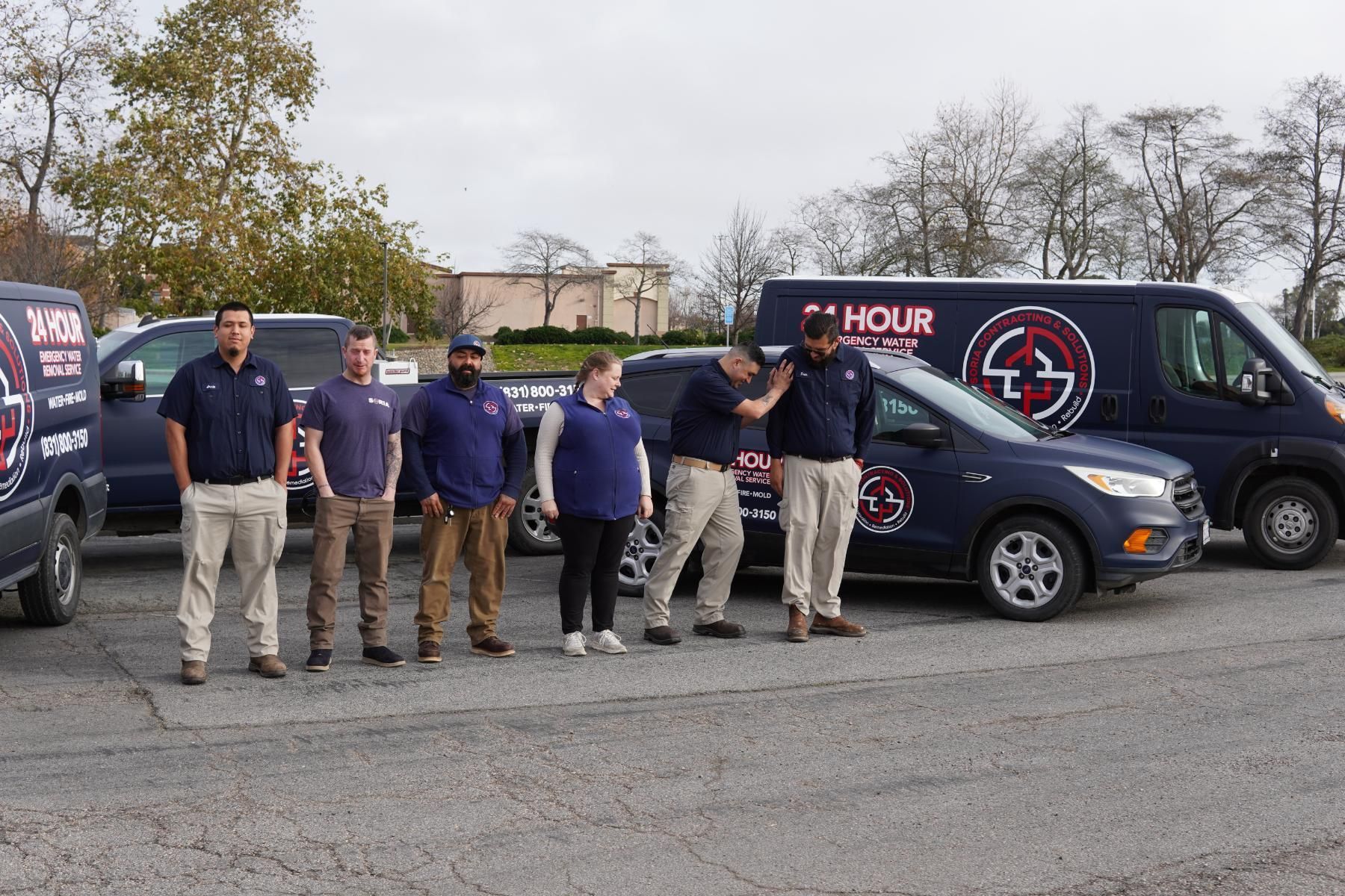 a group of people standing in front of a 24 hour van .