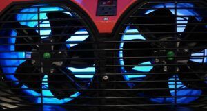 a close up of two fans with blue lights on them