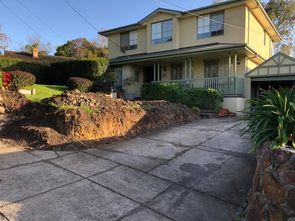 A large house with a large pile of dirt in front of it.