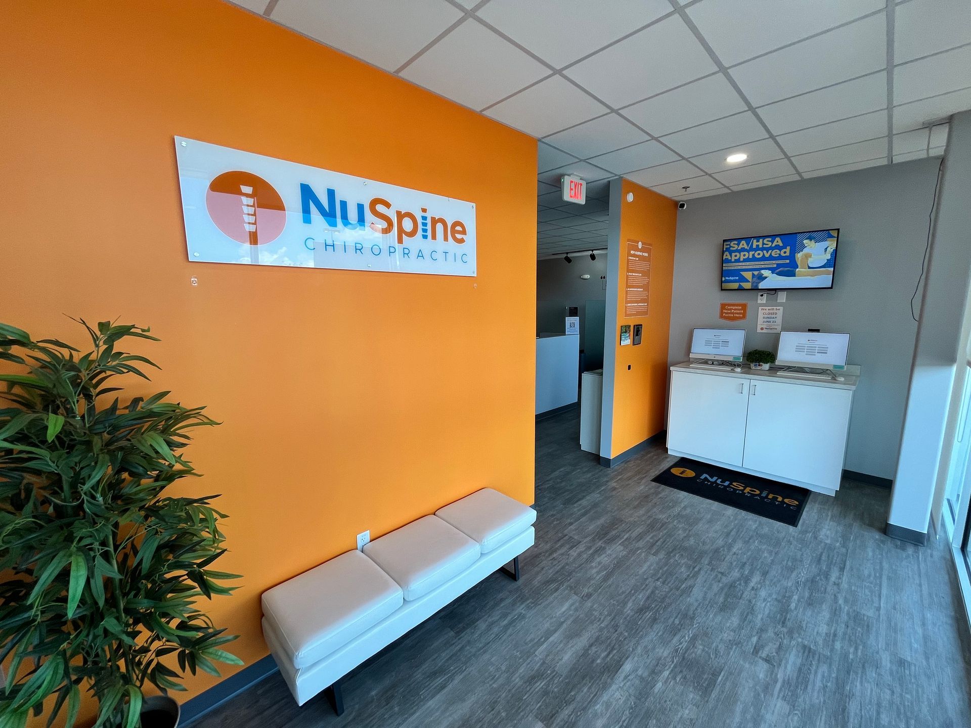 There is a sign on the wall that says nu spine on it.