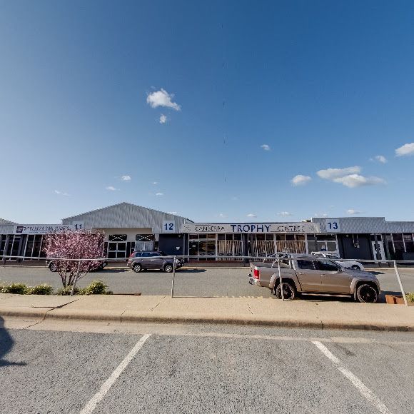 A Parking Lot with Cars Parked in Front of A Building — Canberra Brake & Clutch Service In ACT, 2609