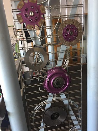 A Bunch of Clutch Discs Are Hanging on A Rack — Canberra Brake & Clutch Service In ACT, 2609