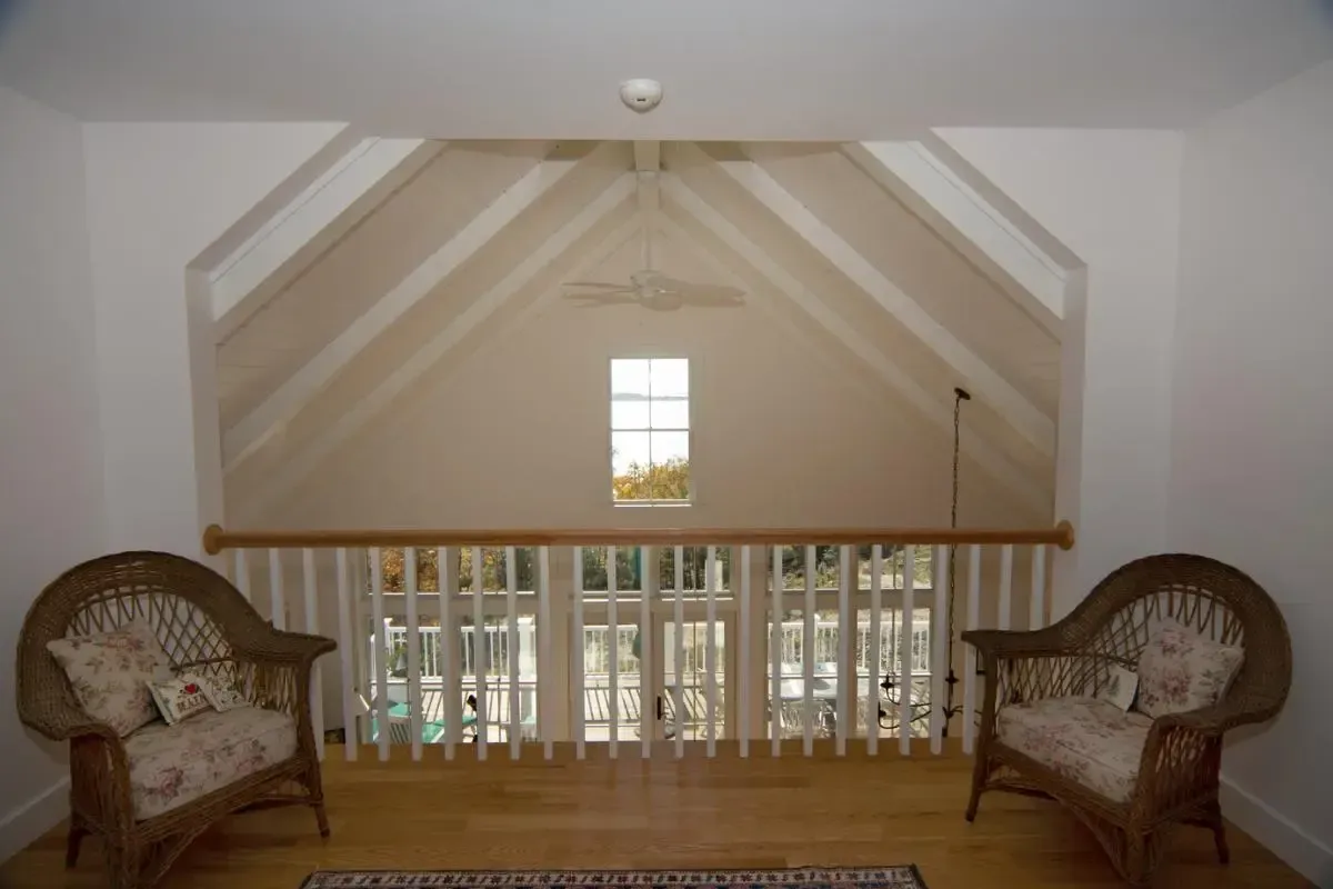 A room with wicker chairs and a window