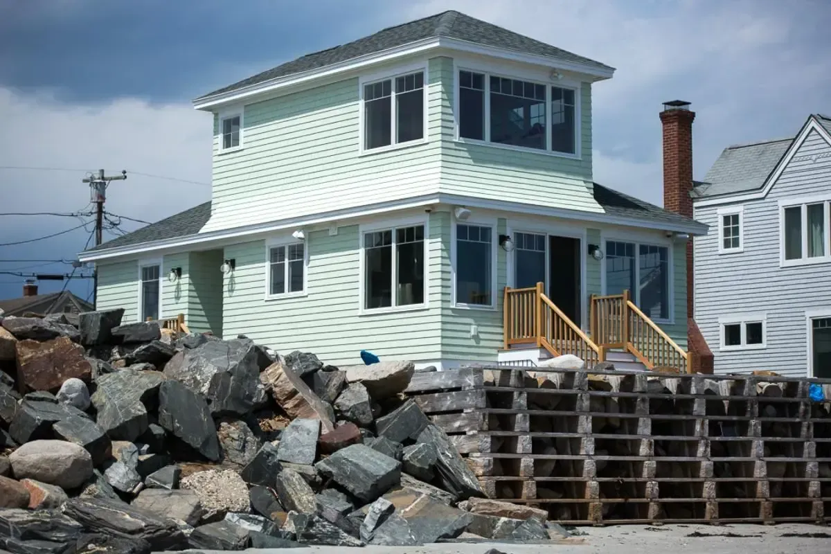 A house is sitting on top of a pile of rocks.