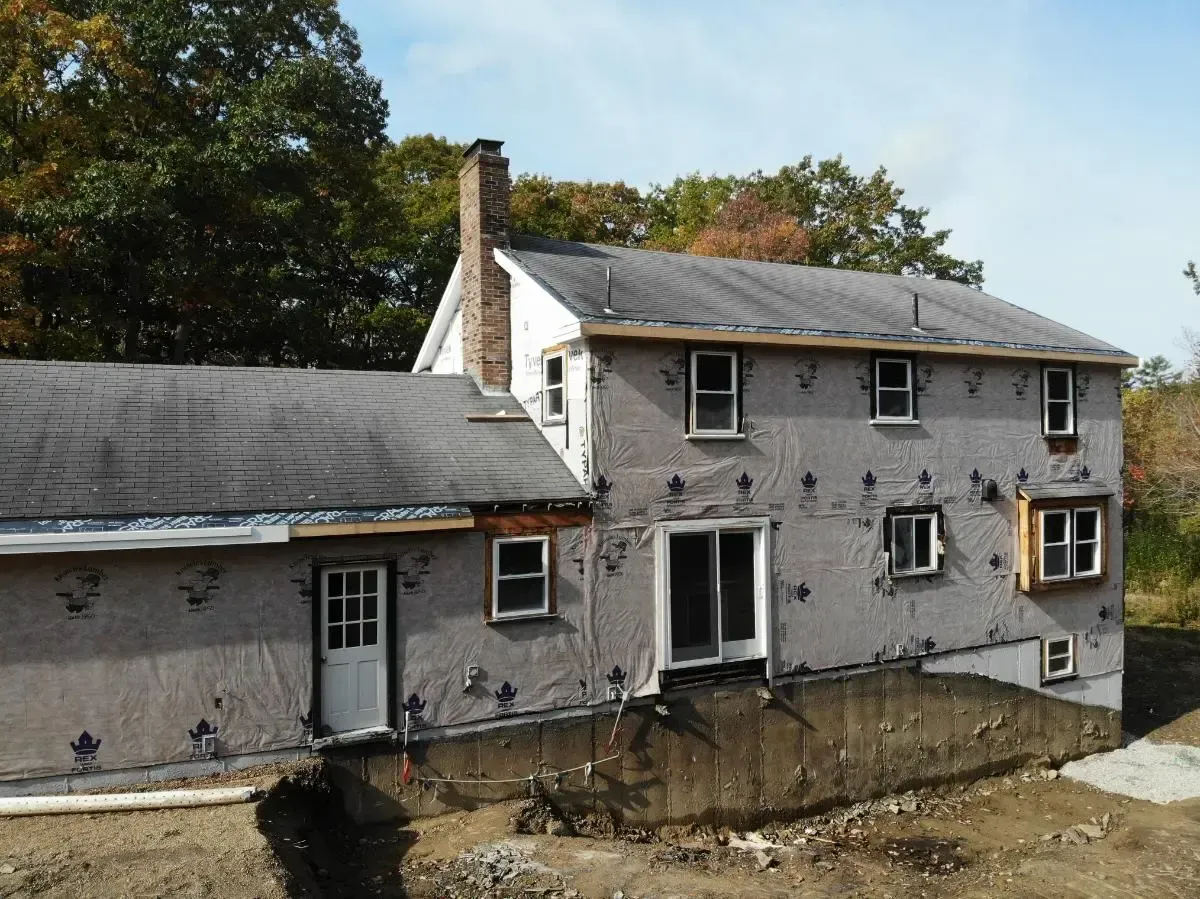 A house with a lot of windows is being remodeled