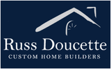 A blue logo for russ doucette custom home builders