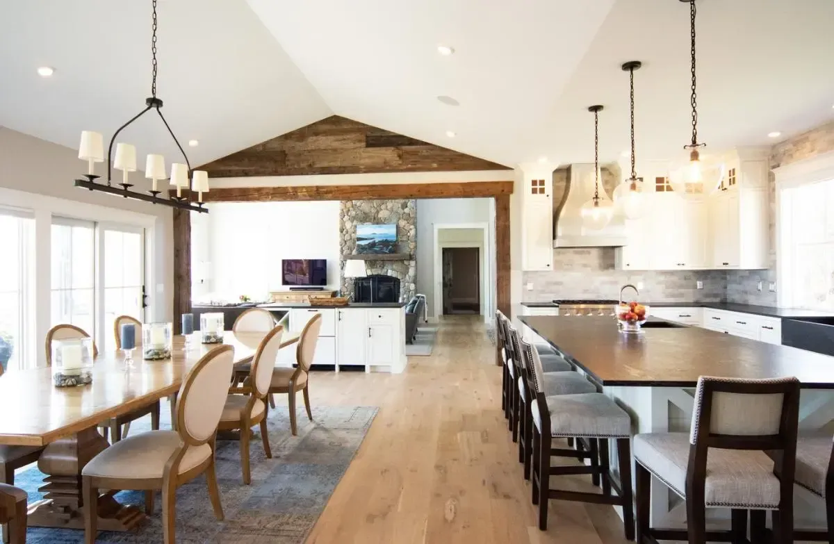 A kitchen and dining room with a long table and chairs