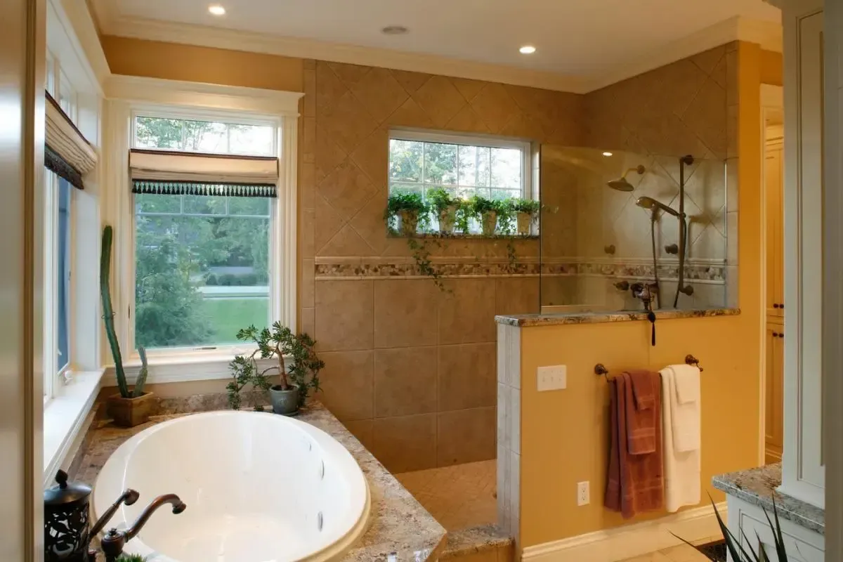 A bathroom with a tub and a walk in shower