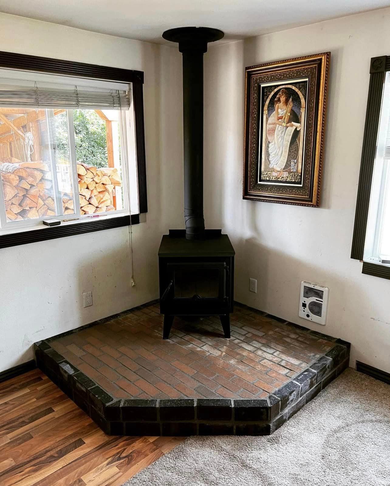 There is a wood stove in the corner of the room.