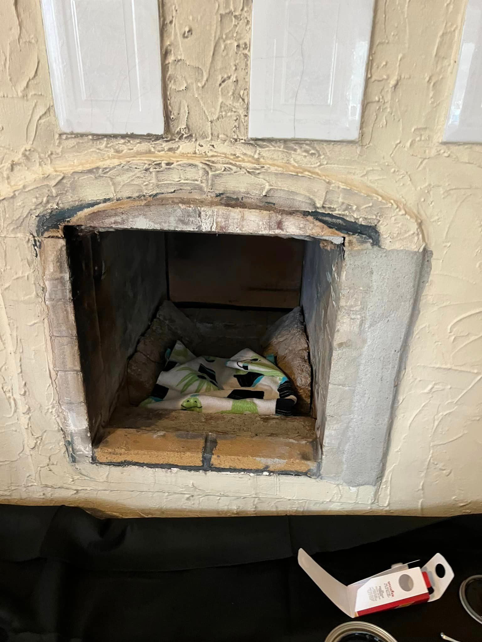 A brick oven with a piece of pizza in it.