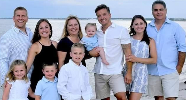 Brooks family posing for a picture on the beach.