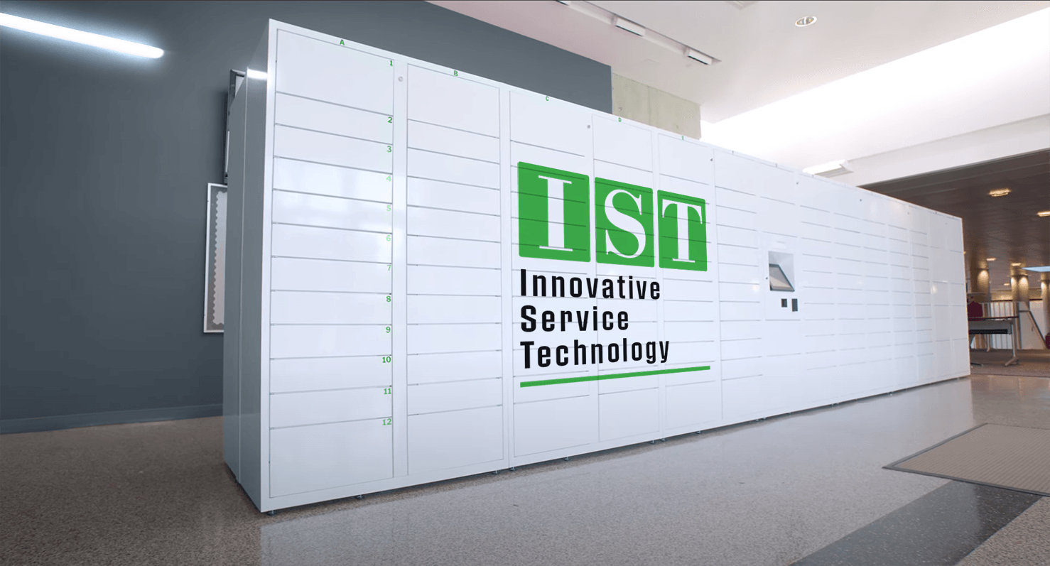 IST Innovative Service Technology sign on a white wall in a modern office lobby