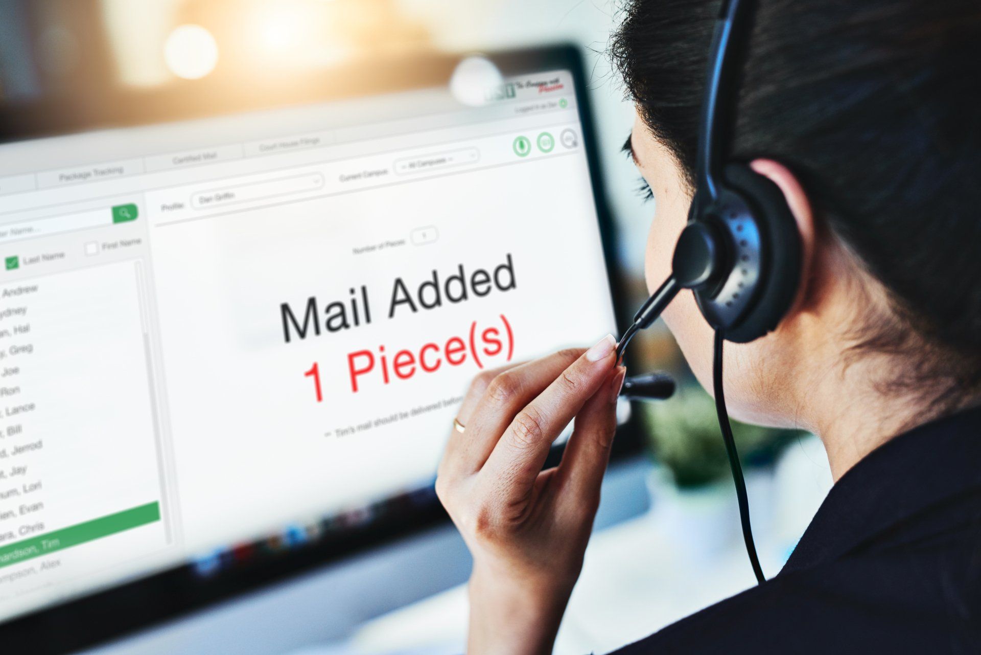 Call center agent in headset viewing screen with “Mail Added 1 Piece(s)” message