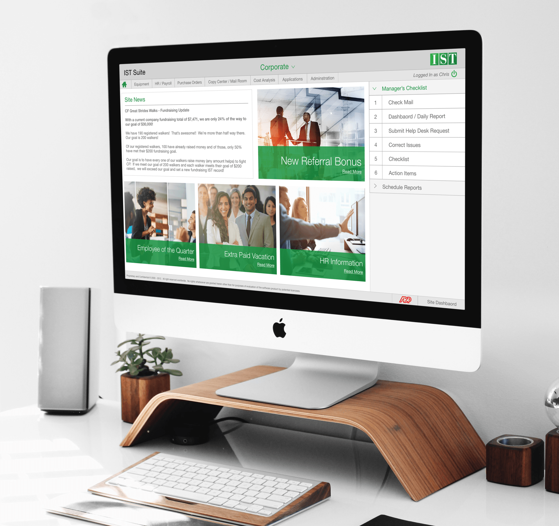 Modern desk setup with iMac, wooden stand, keyboard, plant, and a web page on screen