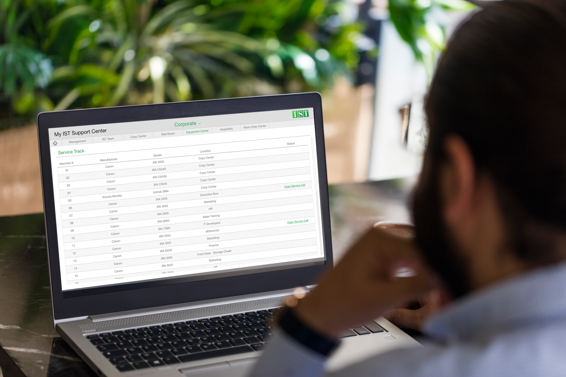 Person viewing a spreadsheet on a laptop in a bright office setting