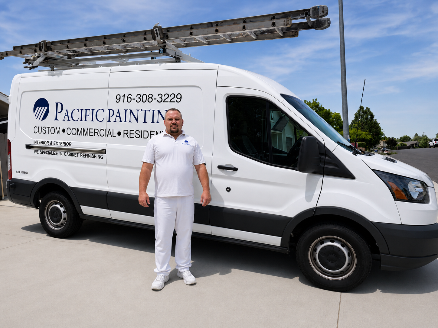 A painter standing in front of a Pacific Painting commercial van.